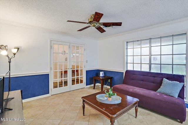 living room featuring a textured ceiling, tile patterned flooring, a ceiling fan, french doors, and crown molding