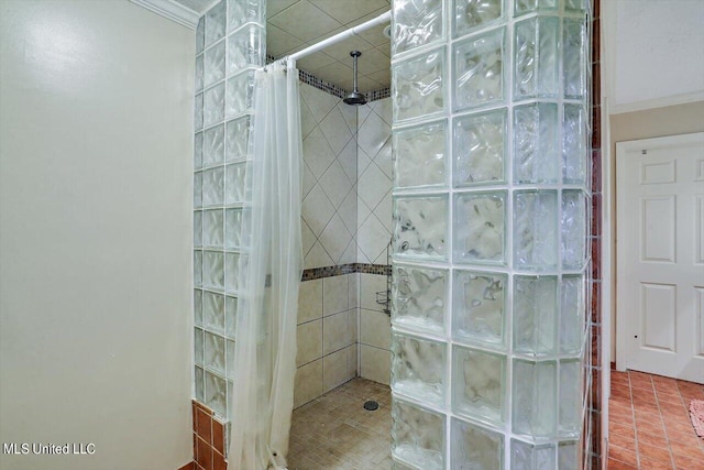 bathroom with ornamental molding, tile patterned flooring, and walk in shower