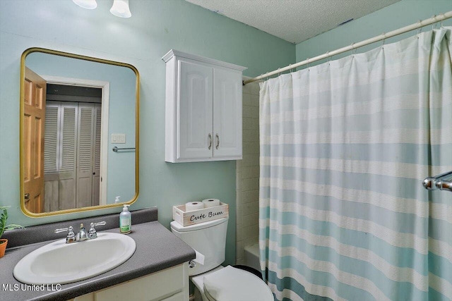 full bathroom with vanity, a textured ceiling, shower / tub combo with curtain, and toilet