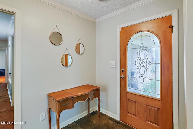 foyer featuring crown molding, a textured ceiling, and baseboards