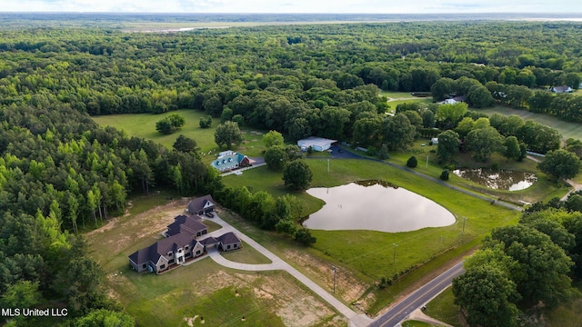 aerial overview of property's location with a heavily wooded area and a large body of water