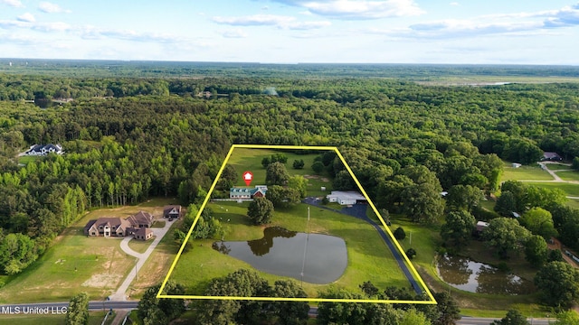 aerial view of property's location featuring a heavily wooded area, a large body of water, and property parcel outlined