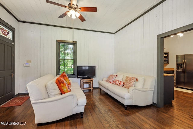 living room featuring ceiling fan, wooden walls, and dark hardwood / wood-style floors