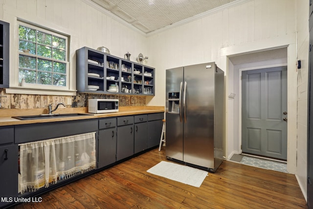 kitchen with stainless steel fridge with ice dispenser, dark hardwood / wood-style floors, gray cabinetry, crown molding, and sink