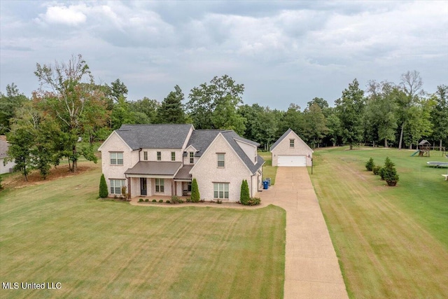 view of front of house with a garage and a front lawn