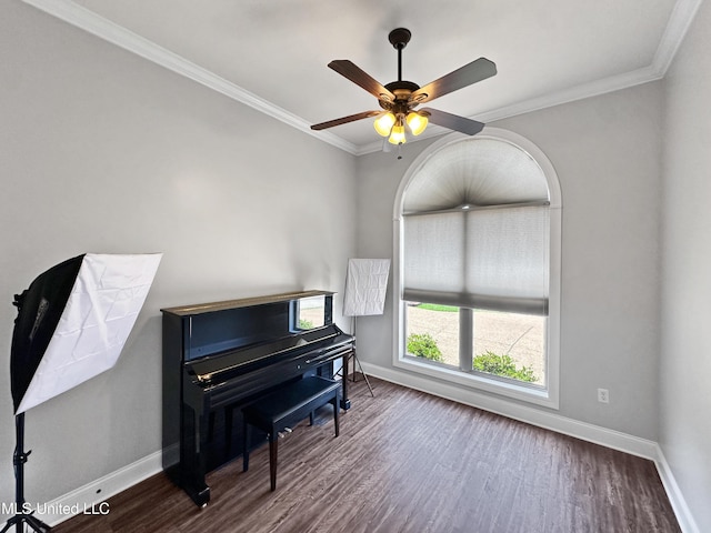 sitting room with baseboards, ornamental molding, ceiling fan, and dark wood-type flooring