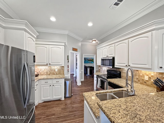 kitchen featuring a sink, appliances with stainless steel finishes, light stone counters, and visible vents