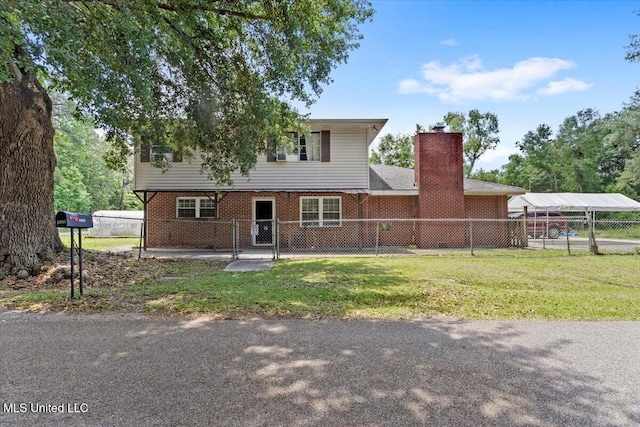 6005 Cypress Dr, Kiln, MS 39556 - view of front of home with a chimney, brick siding, and a carport