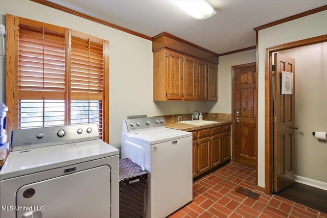 121 Countrywood Cir, Clinton, MS 39056 - washroom featuring washing machine and dryer, cabinet space, crown molding, brick patterned floors, and baseboards