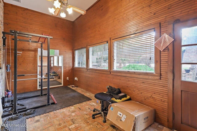 121 Countrywood Cir, Clinton, MS 39056 - exercise area featuring brick flooring, plenty of natural light, and wood walls