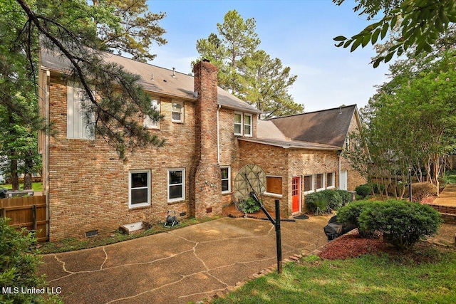 121 Countrywood Cir, Clinton, MS 39056 - rear view of house featuring a chimney, a patio, brick siding, and roof with shingles