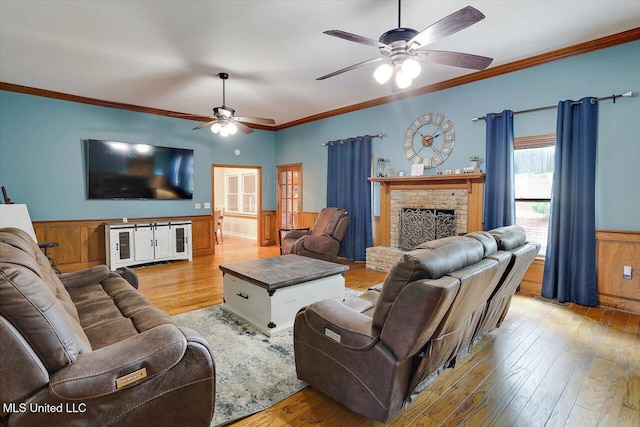 121 Countrywood Cir, Clinton, MS 39056 - living area with a ceiling fan, hardwood / wood-style flooring, a brick fireplace, a wainscoted wall, and ornamental molding