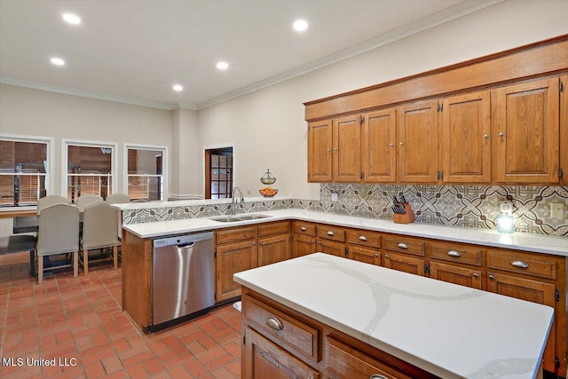121 Countrywood Cir, Clinton, MS 39056 - kitchen featuring stainless steel dishwasher, a sink, light countertops, brown cabinetry, and crown molding