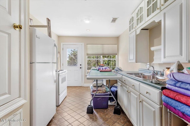 6313 Hermosa Dr, Ocean Springs, MS 39564 - kitchen with white appliances, a sink, white cabinets, glass insert cabinets, and tile patterned floors