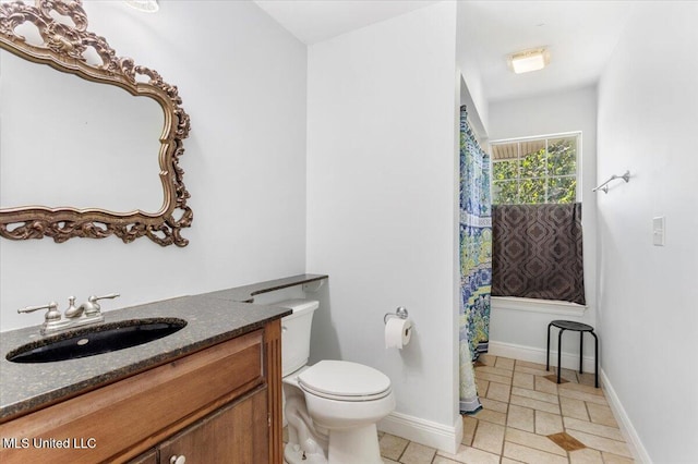 6313 Hermosa Dr, Ocean Springs, MS 39564 - bathroom with toilet, vanity, baseboards, and tile patterned floors
