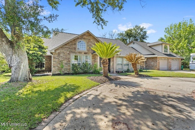 6313 Hermosa Dr, Ocean Springs, MS 39564 - traditional-style home featuring a front yard, concrete driveway, a garage, and stone siding