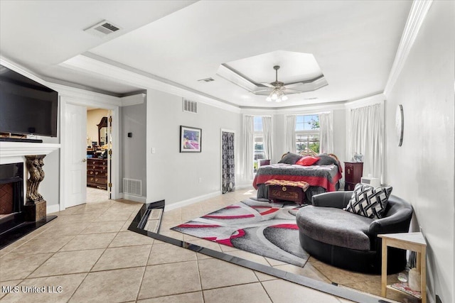 6313 Hermosa Dr, Ocean Springs, MS 39564 - bedroom featuring a raised ceiling, light tile patterned floors, a fireplace with raised hearth, baseboards, and a ceiling fan
