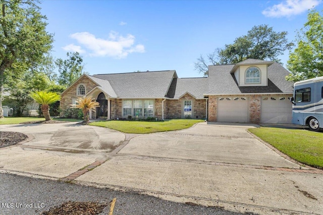 6313 Hermosa Dr, Ocean Springs, MS 39564 - traditional home featuring concrete driveway, a front yard, roof with shingles, and brick siding
