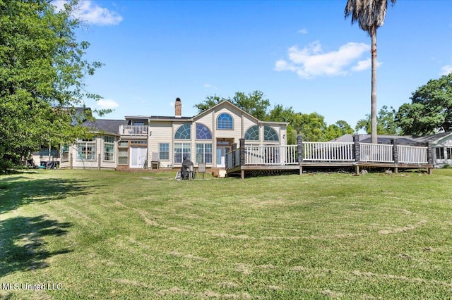 6313 Hermosa Dr, Ocean Springs, MS 39564 - rear view of house featuring a chimney, a lawn, and a deck