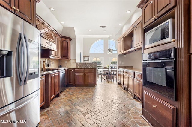6313 Hermosa Dr, Ocean Springs, MS 39564 - kitchen with stainless steel appliances, tasteful backsplash, recessed lighting, a ceiling fan, and brick flooring