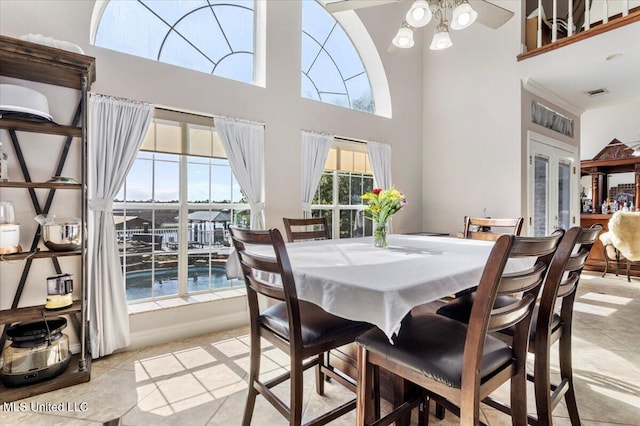 6313 Hermosa Dr, Ocean Springs, MS 39564 - dining space with a towering ceiling, light tile patterned floors, and french doors