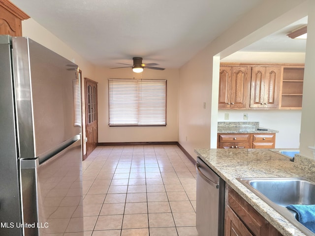 1618 Pear Orchard Pl, Jackson, MS 39211 - kitchen featuring baseboards, ceiling fan, light tile patterned floors, stainless steel appliances, and a sink