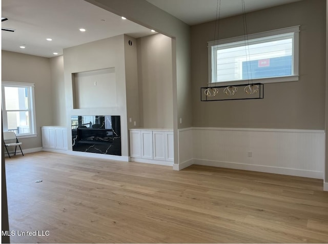 1851 Beach Blvd Unit 4, Biloxi, MS 39531 - unfurnished living room with light wood-style flooring, wainscoting, a fireplace, recessed lighting, and baseboards