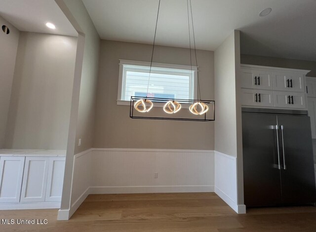 1851 Beach Blvd Unit 4, Biloxi, MS 39531 - unfurnished dining area with light wood-style floors and a wainscoted wall