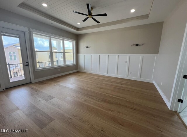 1851 Beach Blvd Unit 4, Biloxi, MS 39531 - spare room featuring a raised ceiling, wood finished floors, ceiling fan, wainscoting, and recessed lighting