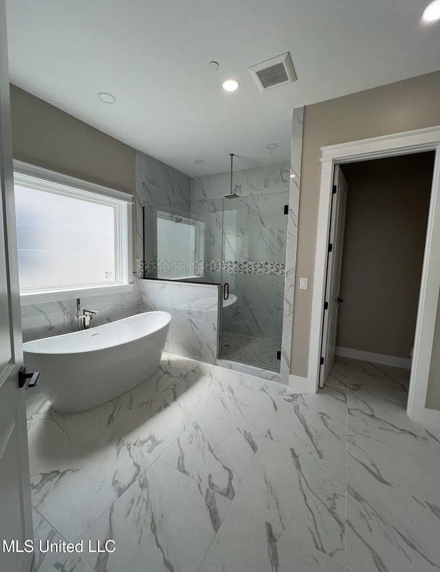 1851 Beach Blvd Unit 4, Biloxi, MS 39531 - full bath with a marble finish shower, a freestanding bath, marble finish flooring, recessed lighting, and baseboards