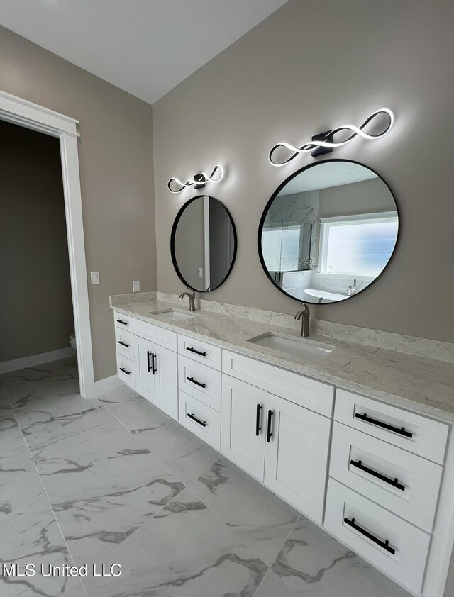 1851 Beach Blvd Unit 4, Biloxi, MS 39531 - bathroom with double vanity, marble finish flooring, toilet, and baseboards
