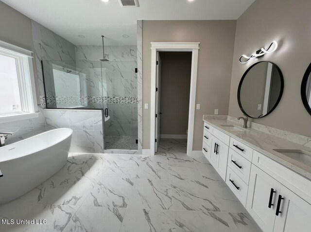 1851 Beach Blvd Unit 4, Biloxi, MS 39531 - bathroom featuring a marble finish shower, double vanity, marble finish floors, a freestanding tub, and baseboards