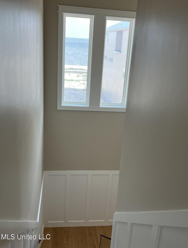 1851 Beach Blvd Unit 4, Biloxi, MS 39531 - empty room featuring wainscoting, a decorative wall, and wood finished floors