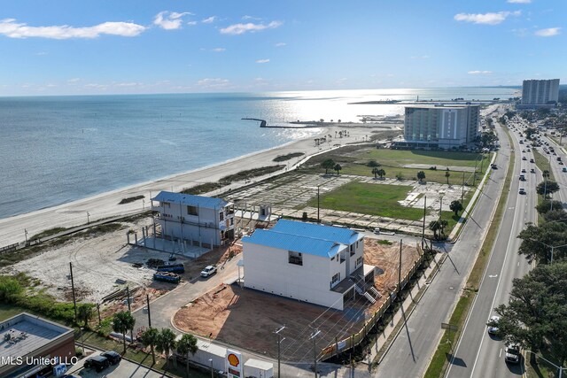 drone / aerial view featuring a water view and a beach view