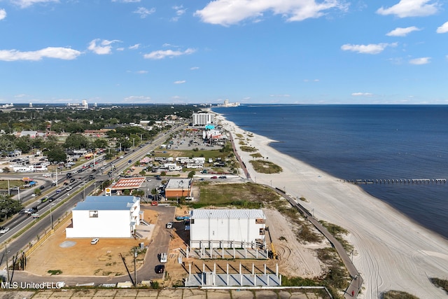 birds eye view of property featuring a water view and a beach view