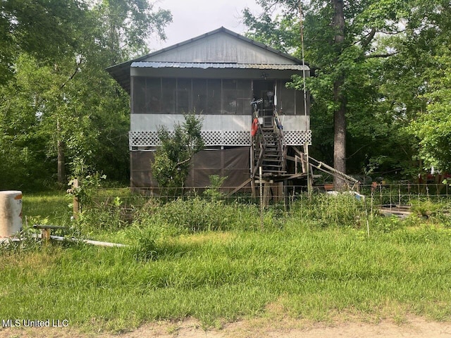 exterior space with a sunroom and stairway