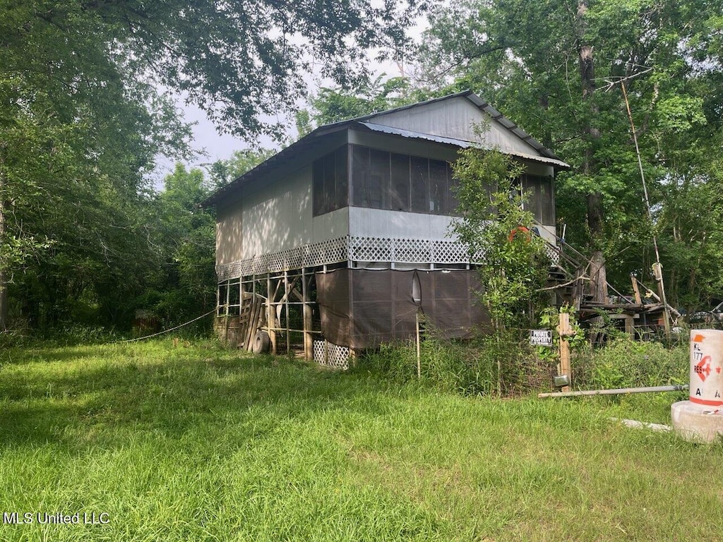 view of side of property featuring a sunroom