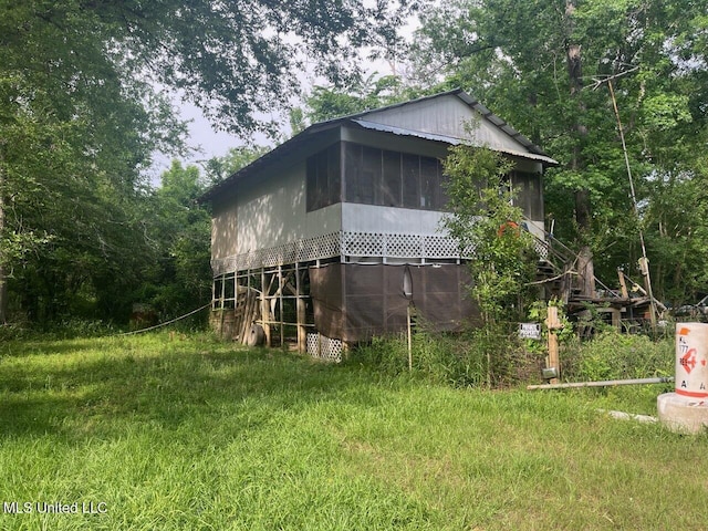 view of side of property featuring a sunroom