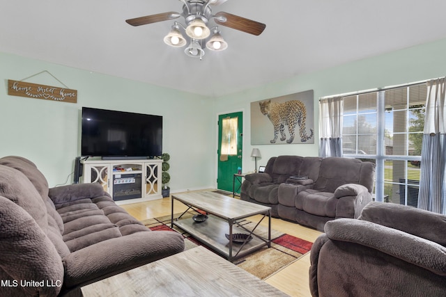 living room featuring light wood-type flooring and ceiling fan