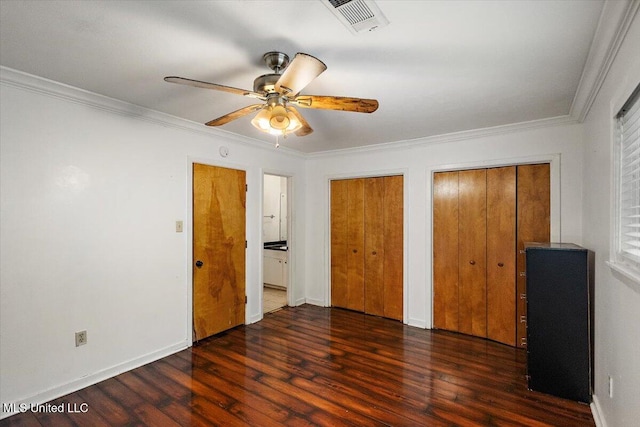 101 Lake Of Pines Dr, Jackson, MS 39206 - unfurnished bedroom featuring multiple closets, wood finished floors, ornamental molding, baseboards, and ceiling fan