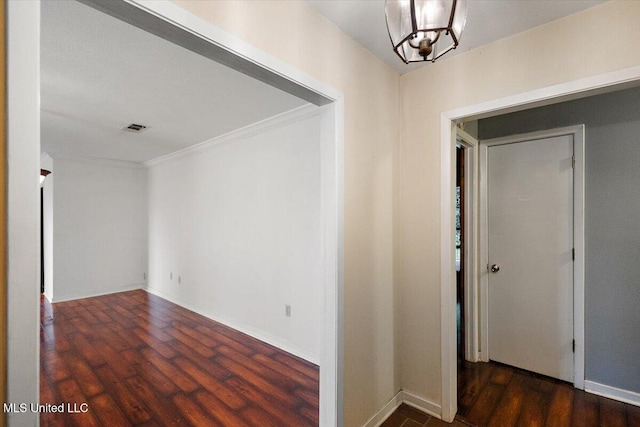101 Lake Of Pines Dr, Jackson, MS 39206 - hall featuring ornamental molding, wood finished floors, a chandelier, and baseboards