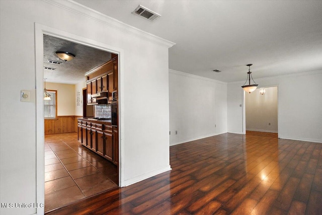 101 Lake Of Pines Dr, Jackson, MS 39206 - empty room with dark wood-style floors, crown molding, a wainscoted wall, and baseboards
