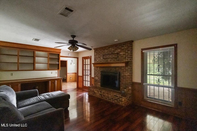 101 Lake Of Pines Dr, Jackson, MS 39206 - living area with dark wood-style floors, wainscoting, a brick fireplace, and ceiling fan