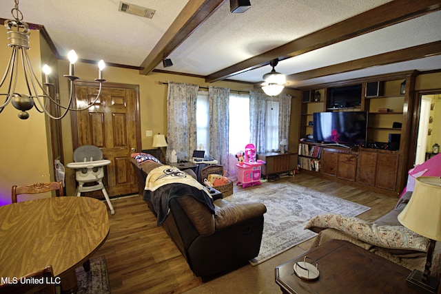 living room featuring beamed ceiling, ceiling fan with notable chandelier, a textured ceiling, and wood-type flooring