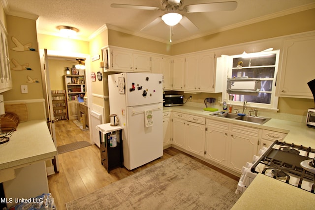 kitchen featuring white cabinetry, light hardwood / wood-style floors, crown molding, sink, and white appliances