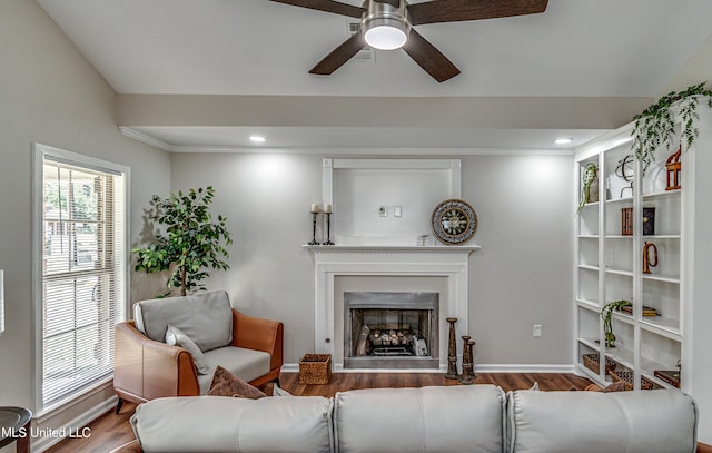 living area with a fireplace with flush hearth, wood finished floors, recessed lighting, and baseboards