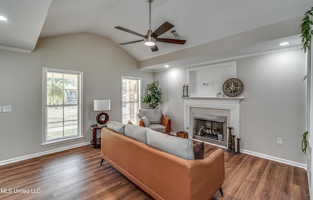 living area featuring a fireplace, vaulted ceiling, wood finished floors, and baseboards