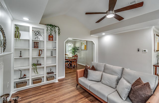 living room featuring wood finished floors, lofted ceiling, arched walkways, ceiling fan, and crown molding