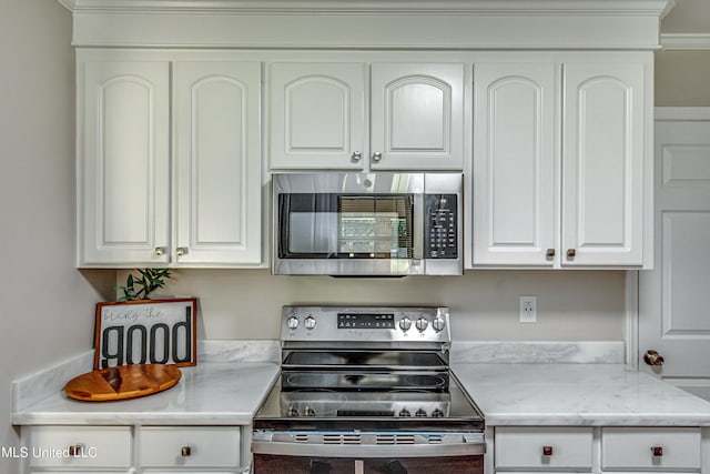 kitchen with appliances with stainless steel finishes and white cabinetry