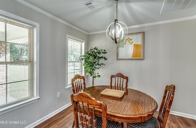 dining room with visible vents, baseboards, dark wood-style flooring, and crown molding